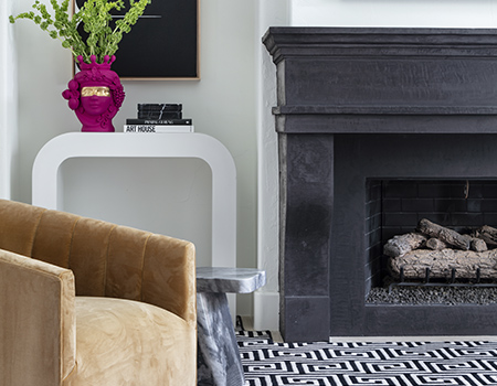 Detail of custom wood fireplace with black and white geometric tile in Houston, TX